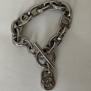 Michael Kors Polished Silver Tone MK Logo-Lock Bracelet.
